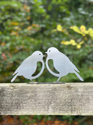 Rusty steel Mr & Mrs Robin fence topper on wooden garden fence - handcrafted metal bird garden art made in Dorset.