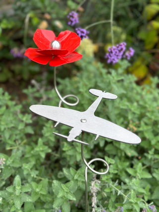 Spitfire stainless steel garden stake with red poppy in background - Remembrance Day garden tribute
