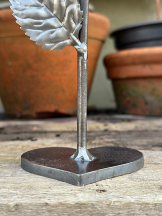 Close up of heart shaped base made from solid 6mm steel on handcrafted metal rose